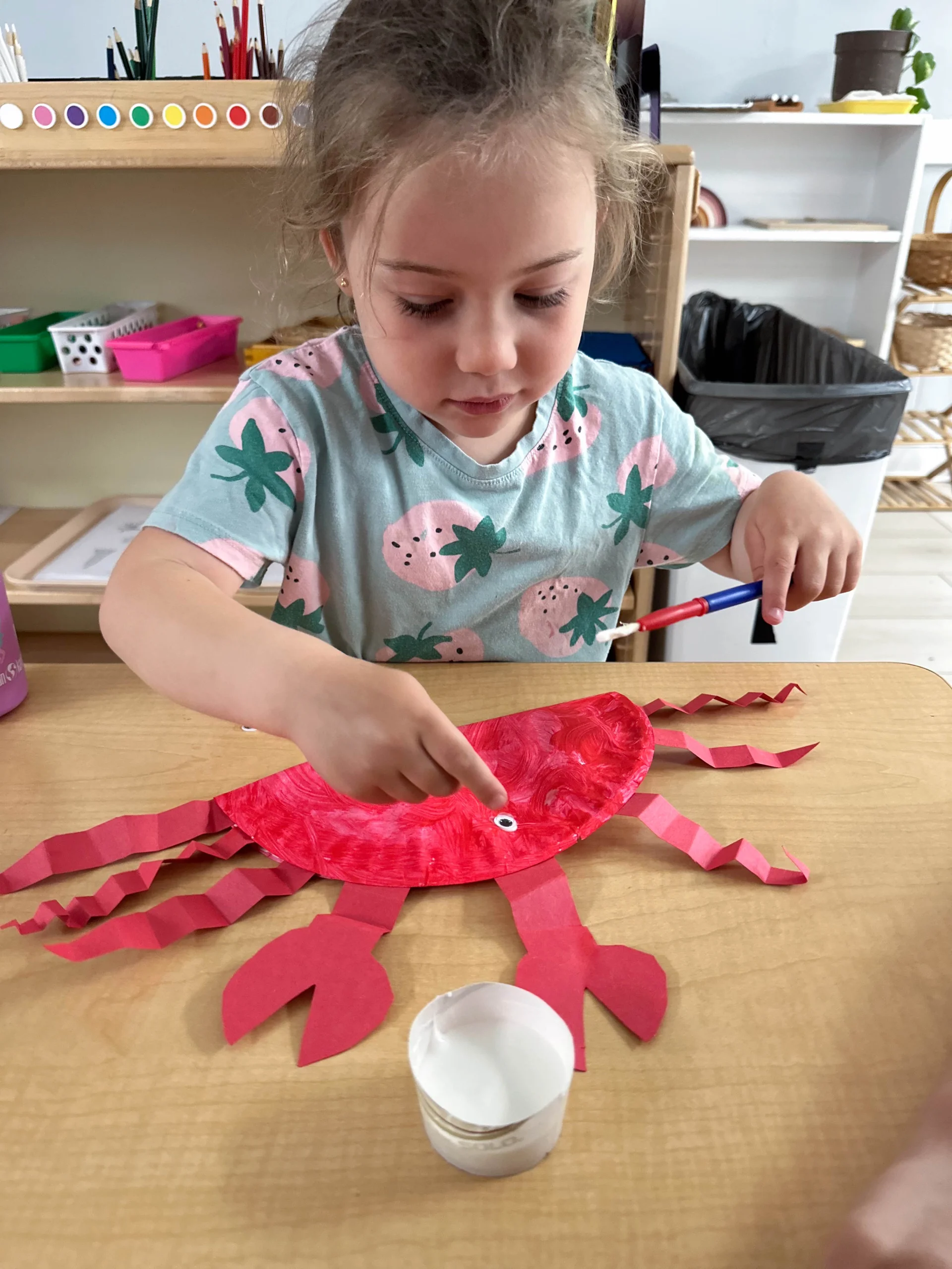 toddler working hard at their arts summer camp